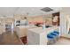 A chef's kitchen with stone floors, breakfast bar, luxury appliances, and bright lighting at 30886 County Road 17/21, Elizabeth, CO 80107