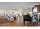 Open living room floor plan with wood floors, fireplace and grand piano at 30886 County Road 17/21, Elizabeth, CO 80107
