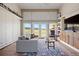 Spacious living room with high ceilings, large windows overlooking open fields, and stylish decor at 30886 County Road 17/21, Elizabeth, CO 80107
