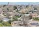 Residential neighborhood view of single-Gathering homes and tree-lined streets with a city skyline in the background at 5540 E Jewell Ave, Denver, CO 80222