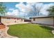 Backyard featuring a lush green lawn and a detached garage at 5540 E Jewell Ave, Denver, CO 80222