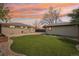 Picturesque backyard featuring manicured lawn, detached garage, patio, and decorative string lights at sunset at 5540 E Jewell Ave, Denver, CO 80222
