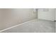 Spacious basement area with neutral paint, plush carpet, and natural light from a small window at 5540 E Jewell Ave, Denver, CO 80222