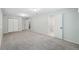 Open carpeted basement with access to other rooms and double-door closet space at 5540 E Jewell Ave, Denver, CO 80222