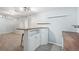 Basement bar area with a wood countertop, white cabinets, seating, and recessed lighting at 5540 E Jewell Ave, Denver, CO 80222
