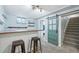 Finished basement featuring a bar area, and sliding barn door at 5540 E Jewell Ave, Denver, CO 80222