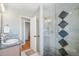 Stylish bathroom featuring granite vanity, glass shower with tiled accents at 5540 E Jewell Ave, Denver, CO 80222
