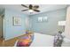 Bright bedroom with a ceiling fan, wood floors, and closet access at 5540 E Jewell Ave, Denver, CO 80222