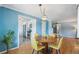 Charming dining area flowing into a bright kitchen and featuring hardwood floors at 5540 E Jewell Ave, Denver, CO 80222