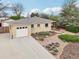Well-maintained exterior with landscaped yard and an attached garage at 5540 E Jewell Ave, Denver, CO 80222