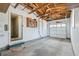 Spacious two-car garage with exposed wood beams, storage, and convenient access to the house at 5540 E Jewell Ave, Denver, CO 80222