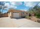 Attached one-car garage and extended driveway offer convenience in this brick home's exterior at 5540 E Jewell Ave, Denver, CO 80222