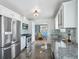 Bright kitchen with stainless steel appliances, granite countertops, and a view to the dining area at 5540 E Jewell Ave, Denver, CO 80222