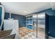 Functional laundry room with a large sink, shelving, modern appliances, and checkered flooring at 5540 E Jewell Ave, Denver, CO 80222