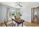 Bright office features a modern desk, stylish chair and french doors and backyard view at 5540 E Jewell Ave, Denver, CO 80222