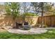 Backyard sitting area features a stylish fire pit and comfortable seating at 942 S Fulton St, Aurora, CO 80247