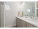 Bright bathroom featuring double vanity and shower with window at 942 S Fulton St, Aurora, CO 80247
