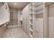 Walk-in closet with custom shelving and ample storage at 942 S Fulton St, Aurora, CO 80247