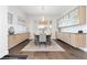 Elegant dining room with modern chandelier, large window, and stylish cabinetry and flooring at 942 S Fulton St, Aurora, CO 80247
