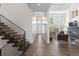 Bright foyer featuring hardwood floors, a modern staircase, and an open view to the living room at 942 S Fulton St, Aurora, CO 80247
