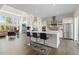 Bright, open kitchen with stainless steel appliances, a large island with seating, and hardwood floors at 942 S Fulton St, Aurora, CO 80247