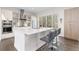 Bright modern kitchen features stainless steel appliances and a large island with bar stool seating at 942 S Fulton St, Aurora, CO 80247