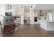 Open-concept living room with a modern fireplace, built-in cabinets, and access to the kitchen at 942 S Fulton St, Aurora, CO 80247
