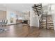 Open living space with hardwood floors, modern staircase, and a view into the dining area at 942 S Fulton St, Aurora, CO 80247