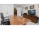 Bright home office featuring a large wooden desk, storage, and modern decor at 942 S Fulton St, Aurora, CO 80247