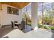 Covered patio features an outdoor dining area, ceiling fan, and backyard access at 942 S Fulton St, Aurora, CO 80247