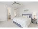 Bright bedroom with ceiling fan, carpet flooring, and ensuite bath at 942 S Fulton St, Denver, CO 80247