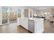 Well-lit kitchen with stainless steel appliances, a central island, and seamless access to the outdoor patio, great for entertaining at 942 S Fulton St, Denver, CO 80247