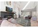 Inviting living room with modern decor, a fireplace, high ceilings, and seamless flow to the kitchen, ideal for entertaining at 942 S Fulton St, Denver, CO 80247
