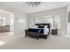 Serene main bedroom with plush carpeting, natural light, and an ensuite bathroom, creating a peaceful retreat at 942 S Fulton St, Denver, CO 80247