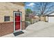 Back door and driveway with detached garage and partial fence at 1454 Utica St, Denver, CO 80204
