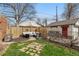 Inviting backyard patio featuring stylish seating, lush greenery, and privacy fencing for outdoor relaxation at 1454 Utica St, Denver, CO 80204