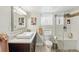 Bright bathroom with glass shower, modern fixtures, and natural stone accents at 1454 Utica St, Denver, CO 80204
