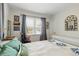 Bedroom with a window, hardwood floors, and neutral-colored walls at 1454 Utica St, Denver, CO 80204