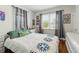 Cozy bedroom with hardwood floors, neutral walls, and bright natural light at 1454 Utica St, Denver, CO 80204