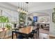 Bright dining area featuring modern lighting and a view into the cozy living room at 1454 Utica St, Denver, CO 80204