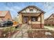 Inviting brick home with a red door, a landscaped yard, and classic architectural charm at 1454 Utica St, Denver, CO 80204