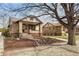 Charming brick bungalow with landscaped front yard and inviting front porch at 1454 Utica St, Denver, CO 80204