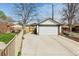 Detached two-car garage with long driveway and white exterior provides ample parking and storage at 1454 Utica St, Denver, CO 80204