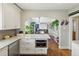 Open kitchen with stainless steel appliances, an island, and an opening to the dining room at 1454 Utica St, Denver, CO 80204