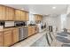 Bright laundry room with newer washer/dryer, ample cabinet space, and stylish tile flooring at 1454 Utica St, Denver, CO 80204