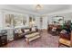 Charming living room with hardwood floors, large windows, and a comfortable seating area at 1454 Utica St, Denver, CO 80204