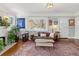 Cozy living room boasting a decorative fireplace, a large window, and hardwood floors at 1454 Utica St, Denver, CO 80204