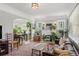 Bright living room featuring hardwood floors, a fireplace, and seamlessly connects to the dining area at 1454 Utica St, Denver, CO 80204