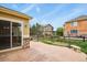 Backyard with a stone patio, bench seating, wood fence, and views of neighboring homes at 297 N Coolidge Way, Aurora, CO 80018