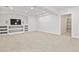 Spacious finished basement featuring a built-in entertainment center, neutral carpeting, and an open floor plan at 297 N Coolidge Way, Aurora, CO 80018